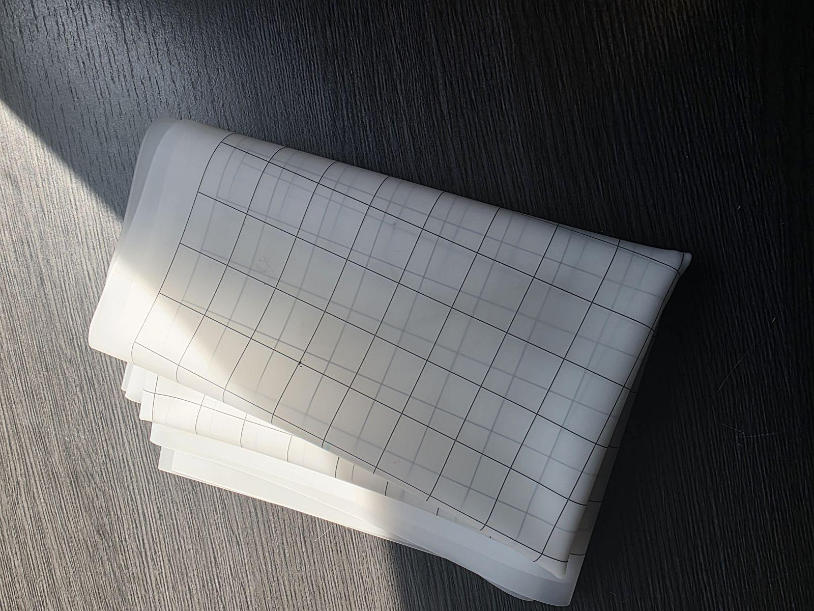 The heyTrace mat folded into a small stack on a wooden table