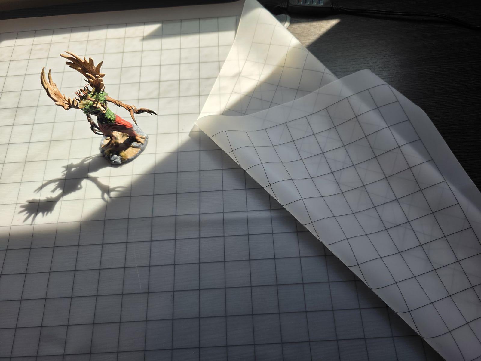 The smaller heyTrace mat lifted over the large one, the grid underneath showing through it