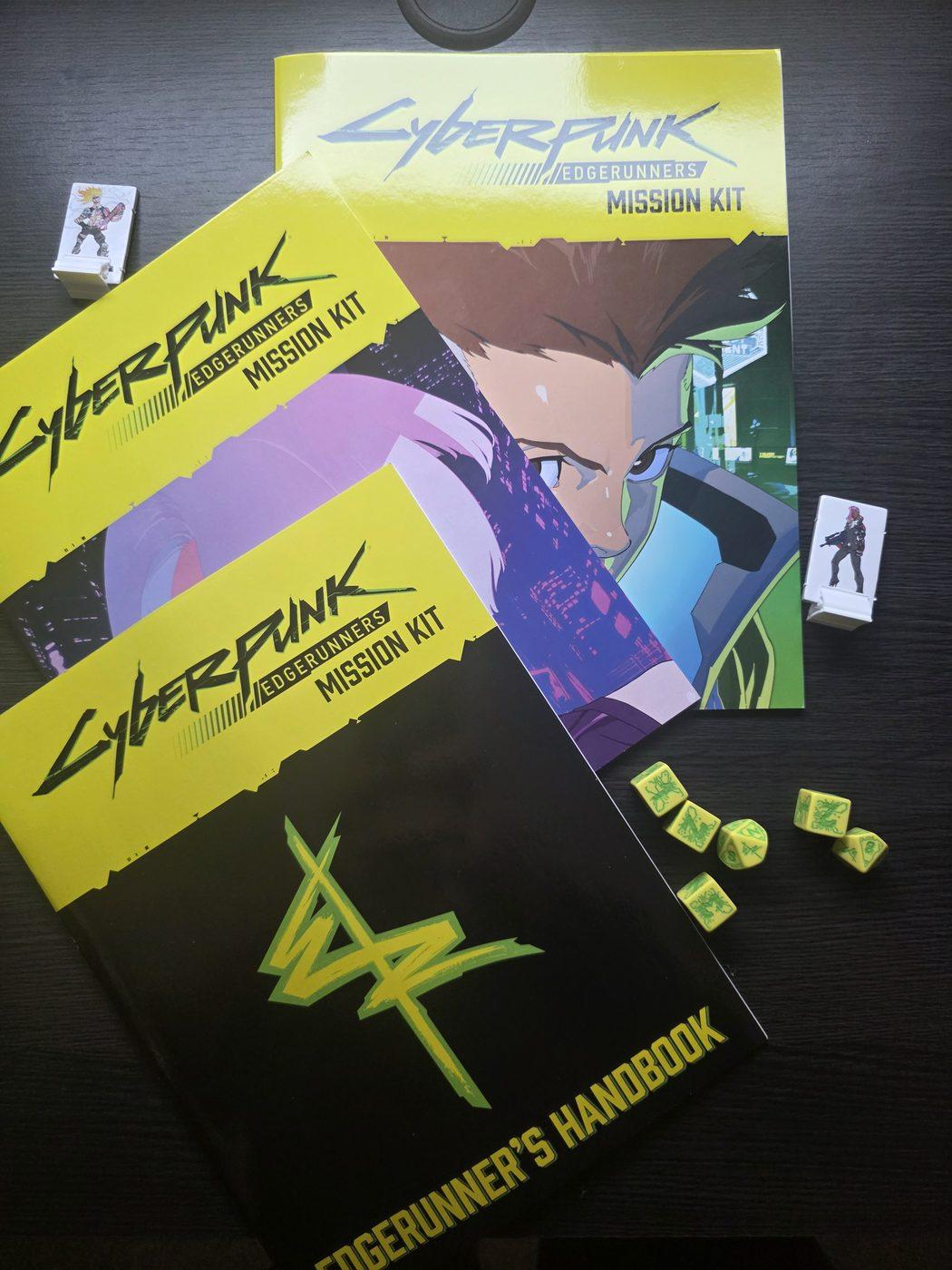 The booklets with two standees and the six yellow and green Edgerunners dice