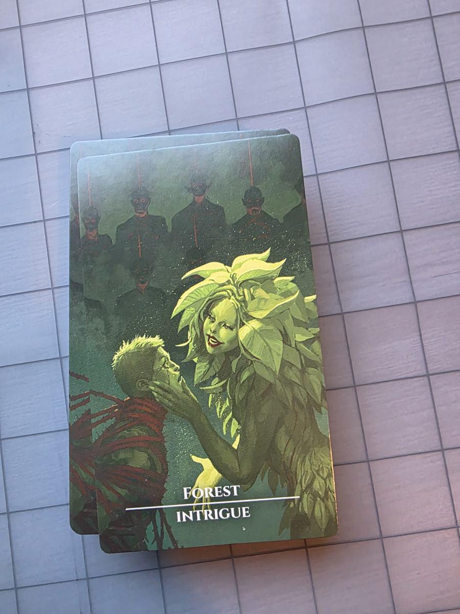 The Forest Intrigue card, a leafy dryad cradling a man's face