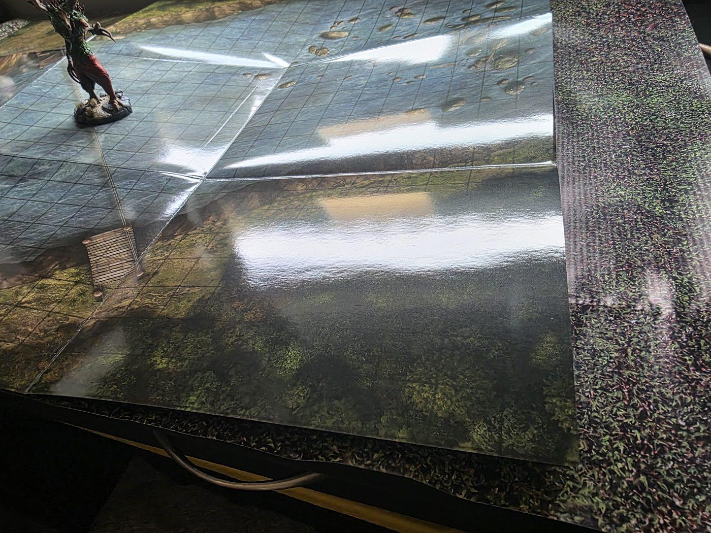 The river crossing map laid out with fold lines and window glare across its glossy surface