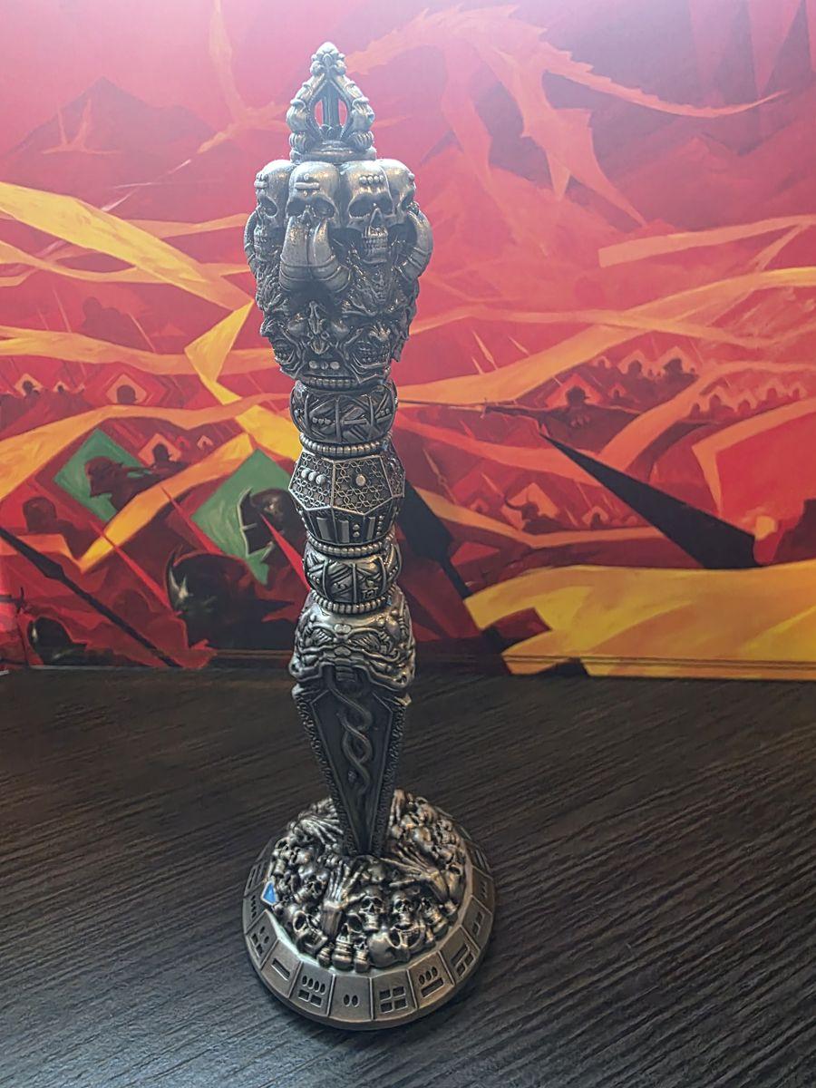 Wand Dice standing upright in its base in front of colorful art